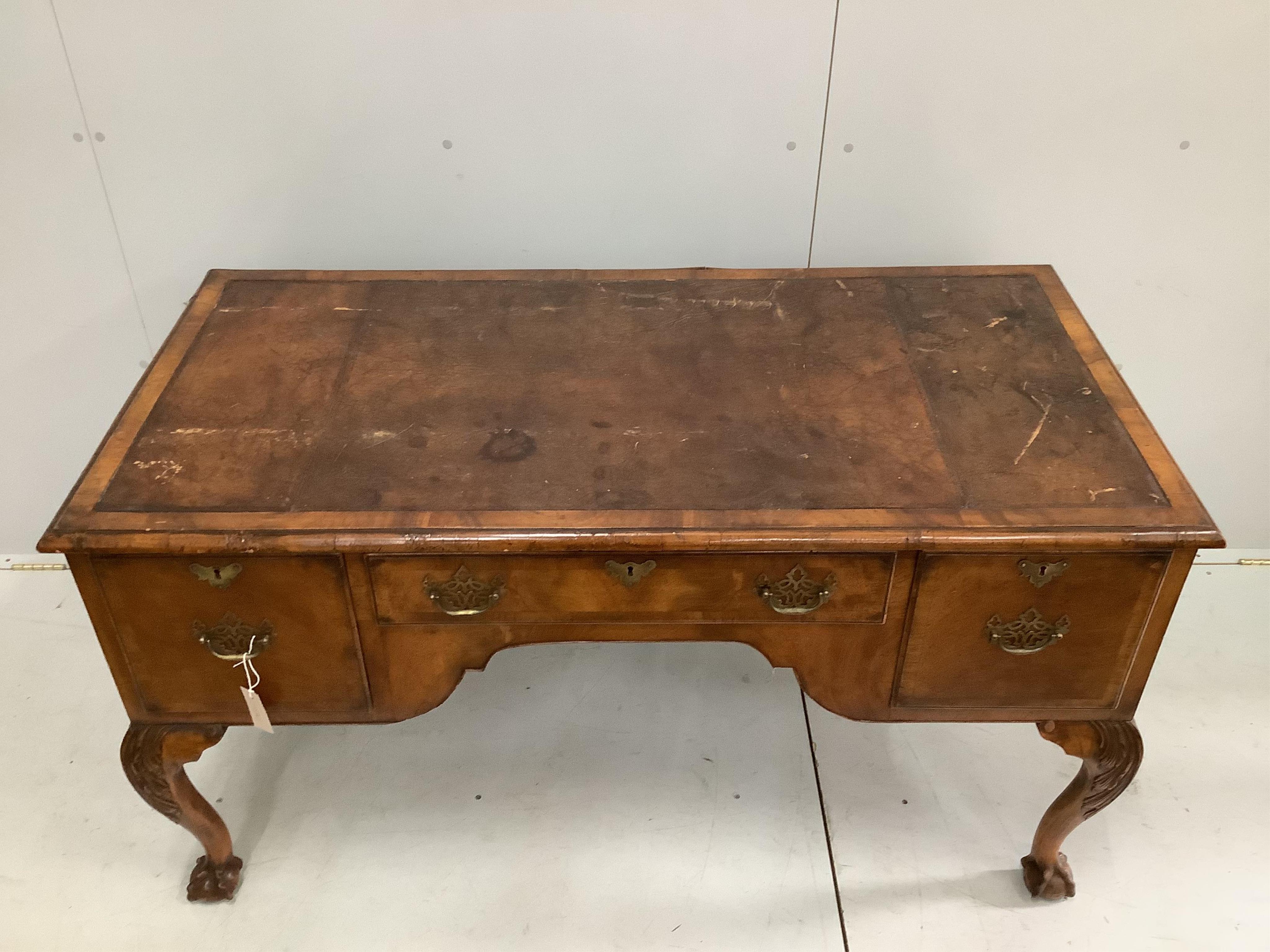 A 1930's walnut kneehole walnut writing table, width 148cm, depth 68cm, height 76cm. Condition - fair to good